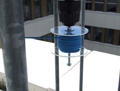 Cable wound up on cable spool attached to screwdriver