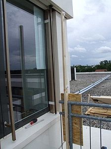 Pulley arm mounted to railing and nearby wall