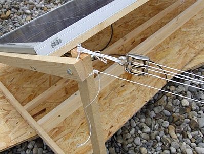 Cabling (twine) routed through double brass pulley and atttached to solar cell framework